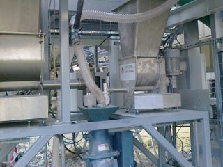 Industrial powder handling and material transfer equipment in a processing plant